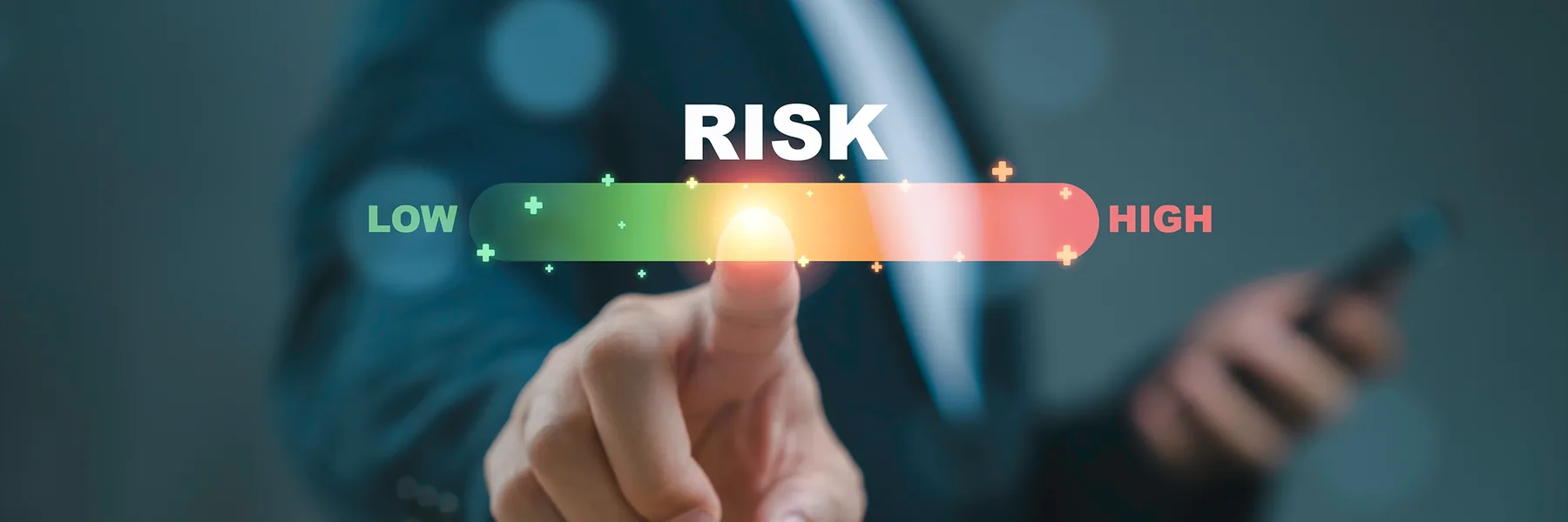 Finger touching a risk scale that runs from low to high